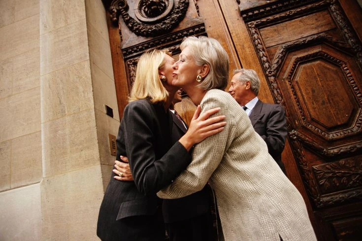 two person greetings with double cheek kiss
