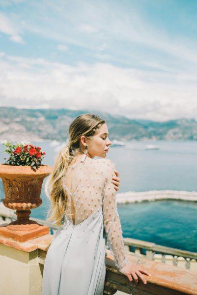 Elegant Woman in Light Blue Dress Overlooking Naples