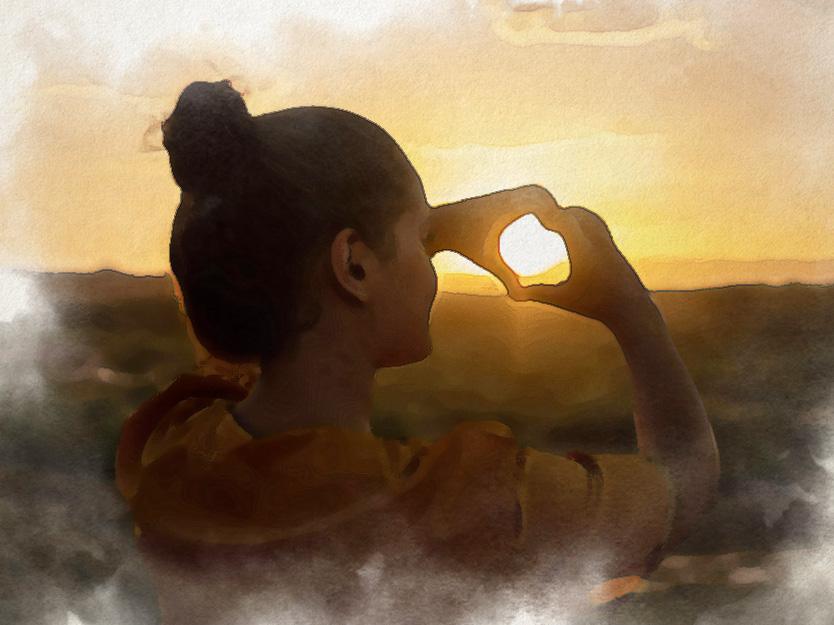 a girl staring at sunset with love sign hand