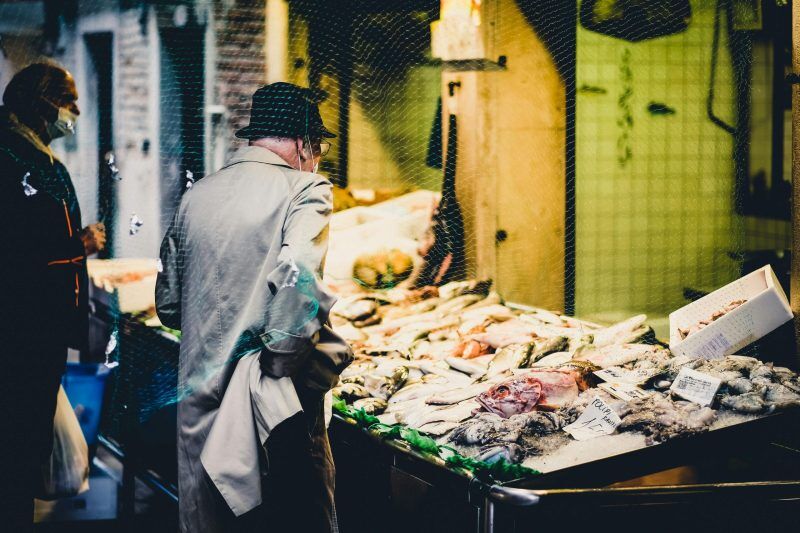 a man buying fish in the market